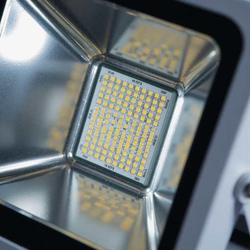 Close-up macro photography of a medium rectangular 5730 surface mount LED chip component, white base substrate, large yellow phosphor area, silver metallic terminals on ends, dark background, sharp focus, electronic component
