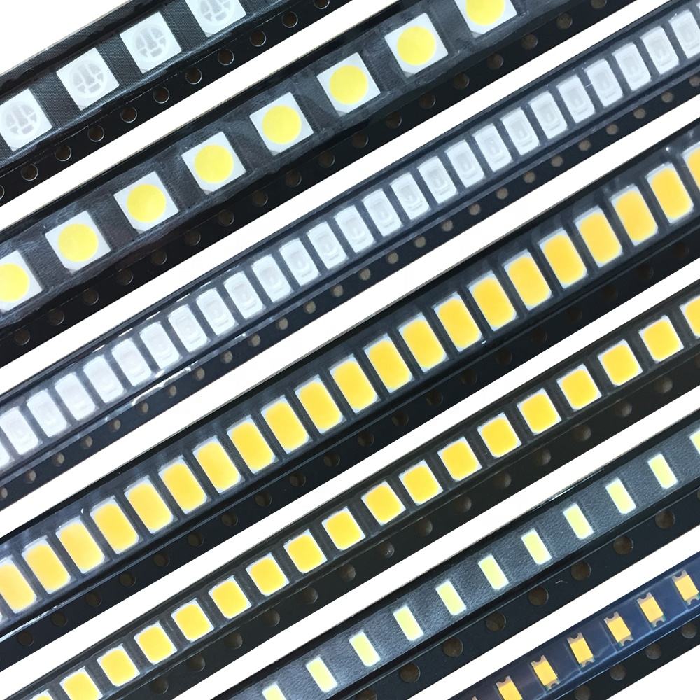 Close-up macro photography of a small rectangular 2835 surface mount LED chip component, white ceramic substrate, yellow phosphor coating center, silver metallic contact pads on edges, dark background, sharp focus, electronic component